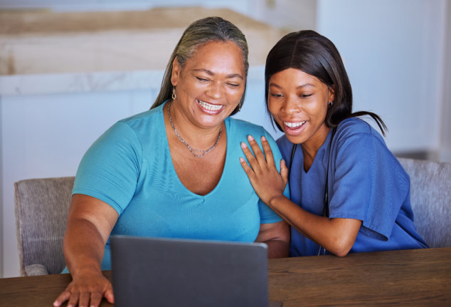 senior woman laughing with her caregiver