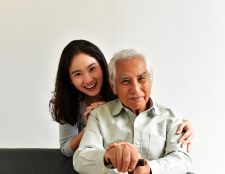 aide and elderly man smiling