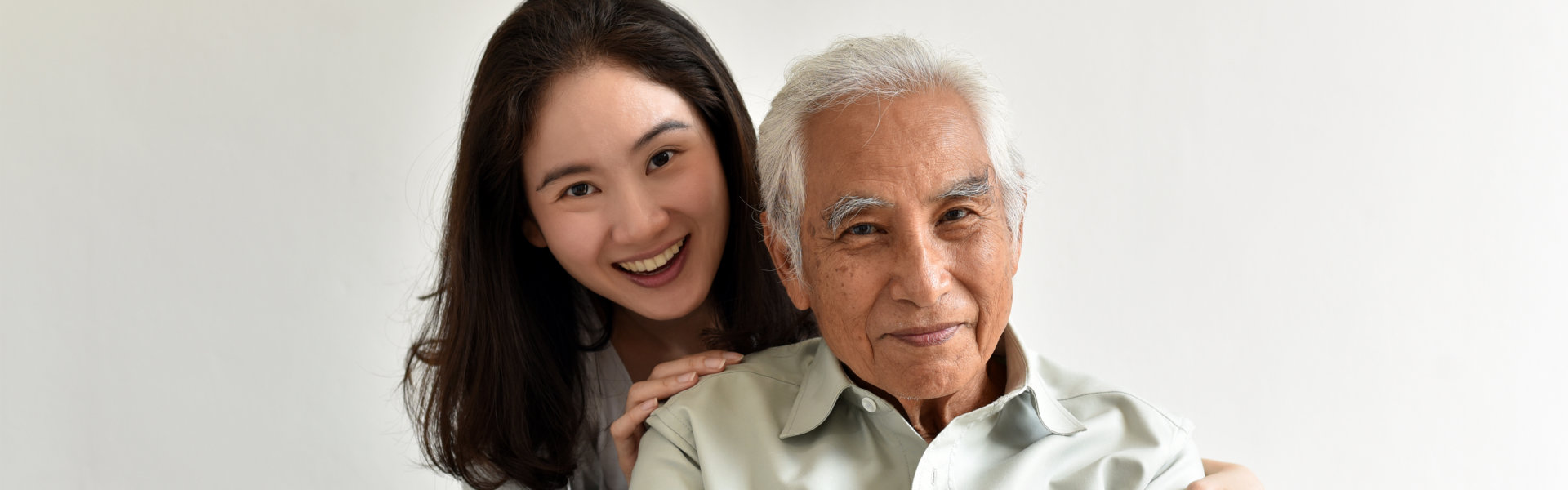 aide and elderly man smiling